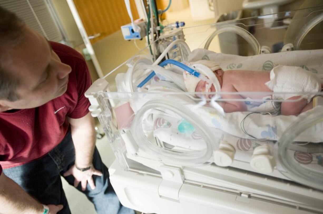 Tim Haag visits his newborn daughter, Bailey, in the neonatal intensive care unit at Legacy Salmon Creek Medical Center Tuesday.