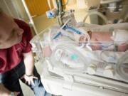 Tim Haag visits his newborn daughter, Bailey, in the neonatal intensive care unit at Legacy Salmon Creek Medical Center Tuesday.