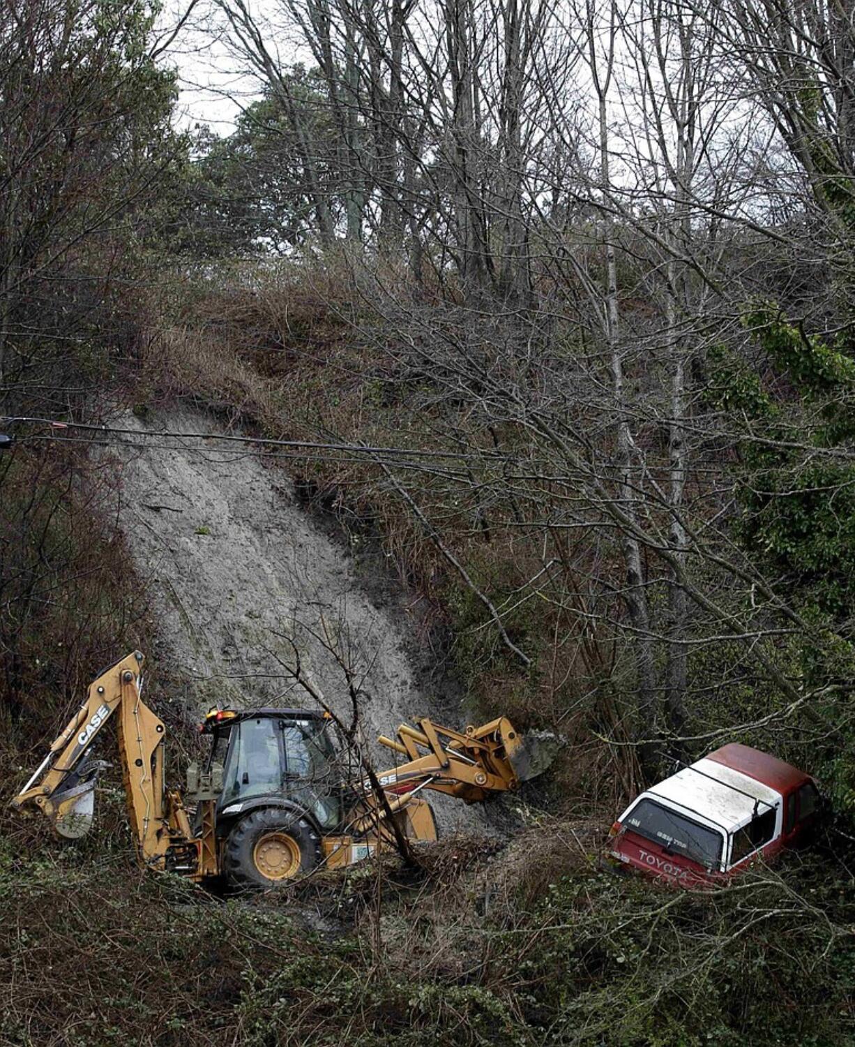 City of Seattle workers clear debris from a mudslide in Seattle's Magnolia neighborhood on Monday in Seattle.