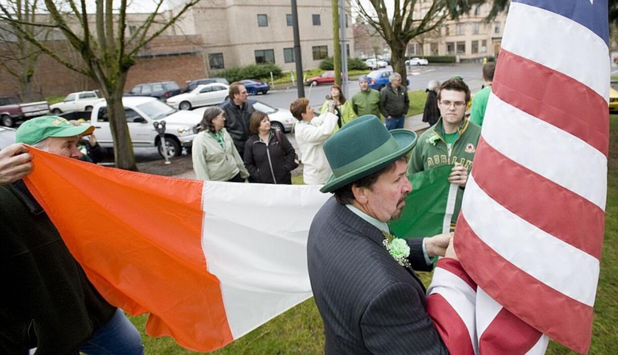 Family and friends of Denny Lane raise the Irish flag at the Clark County Courthouse on St.