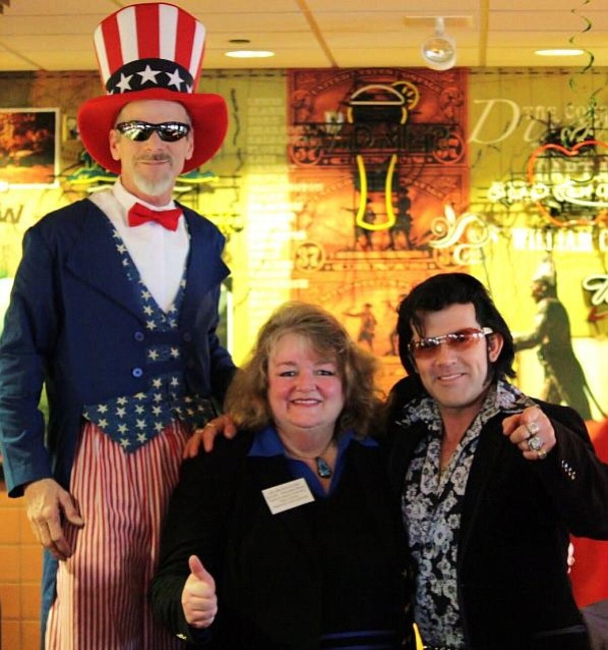 Uncle Sam (Jerry Sallee) and Elvis (Mark Stephens) flank Milada Allen, executive director of the new Clark County Veterans Assistance Center, on March 12 at the &quot;Freedom Flapjack Breakfast.&quot;