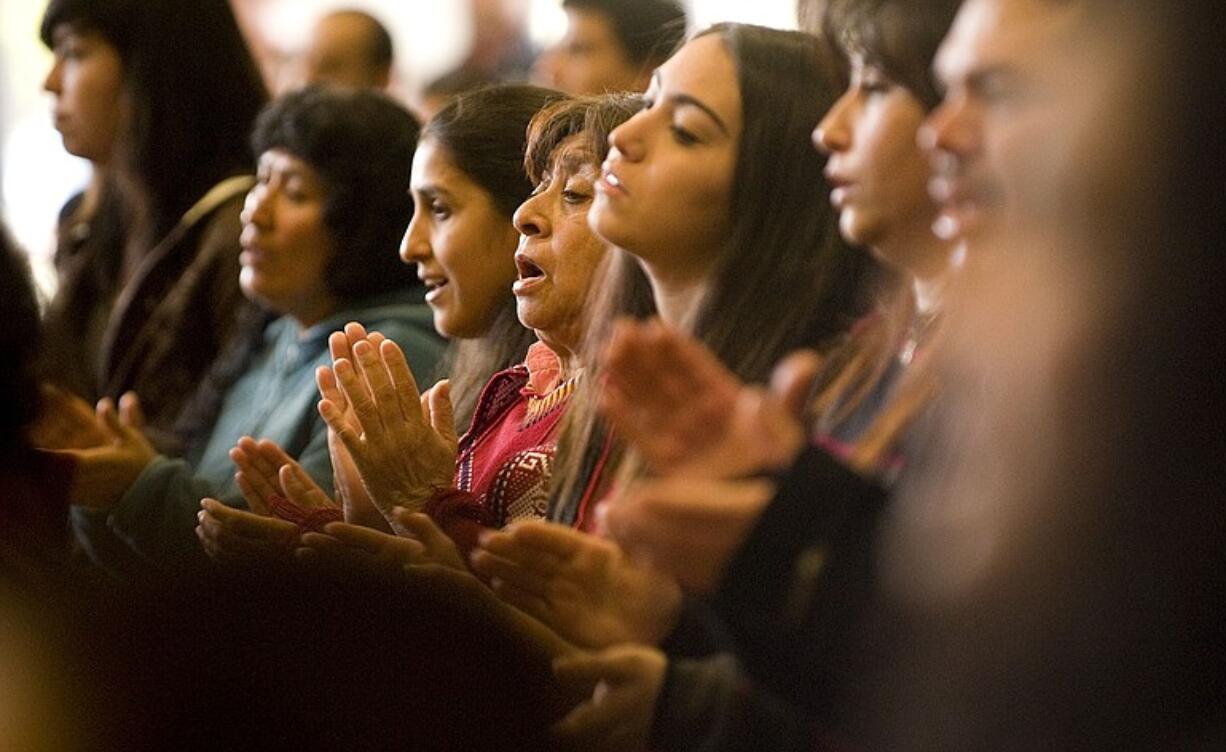 Dora Alicia, center, sings during a Spanish language Mass at St. John Catholic Church in Vancouver on Feb. 20. According to the 2010 Census, the Hispanic population in the U.S.