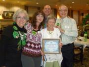 June Clark, holding certificate, won free rent for life at The Bedford retirement community.