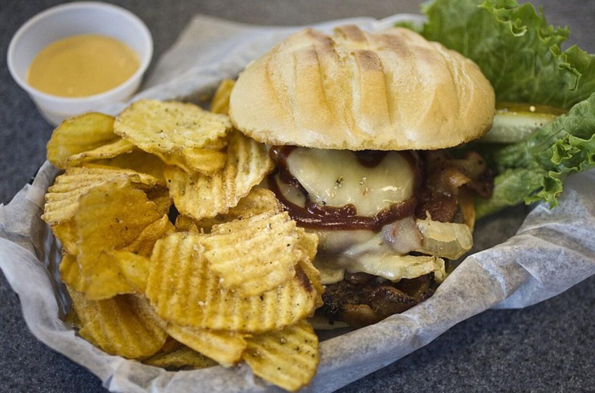 The cheese, pepper-bacon strips, onions and sauces all complement the Mechanical Bull burger's beef patty at Burger Bungalow.