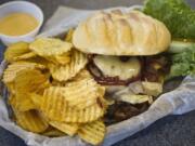 The cheese, pepper-bacon strips, onions and sauces all complement the Mechanical Bull burger's beef patty at Burger Bungalow.