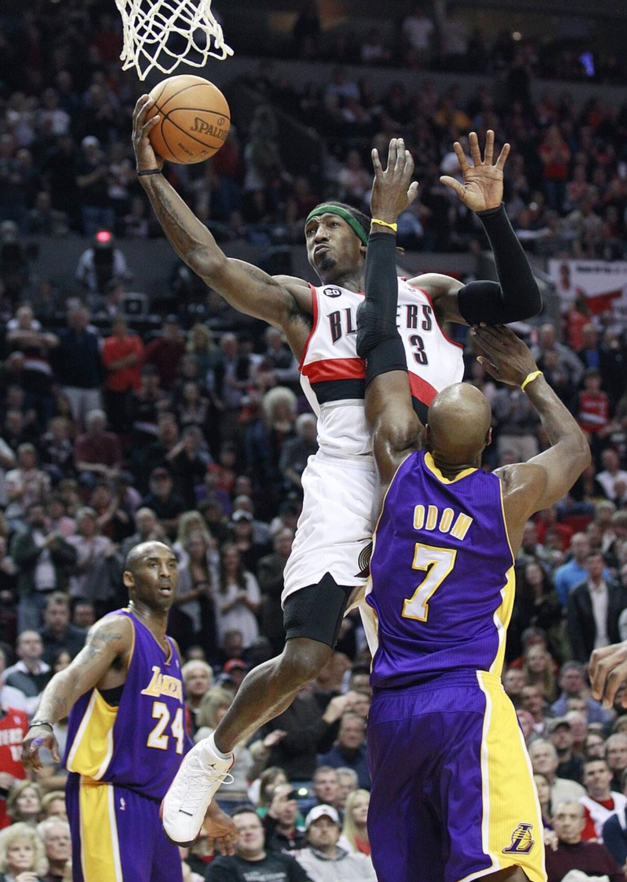 Portland Trail Blazers' Gerald Wallace (3) takes the ball to the basket as Los Angeles Lakers' Lamar Odom (7) defends while teammate Kobe Bryant (24) looks on in the second half during their NBA basketball game Friday, April 8, 2011, in Portland, Ore. The Trail Blazers defeated the Lakers 93-86.