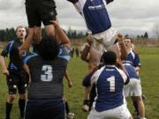 Prairie's Logan Fallon (right) reaches for the ball caught by Vancouver's Anton Weiman in line-out.