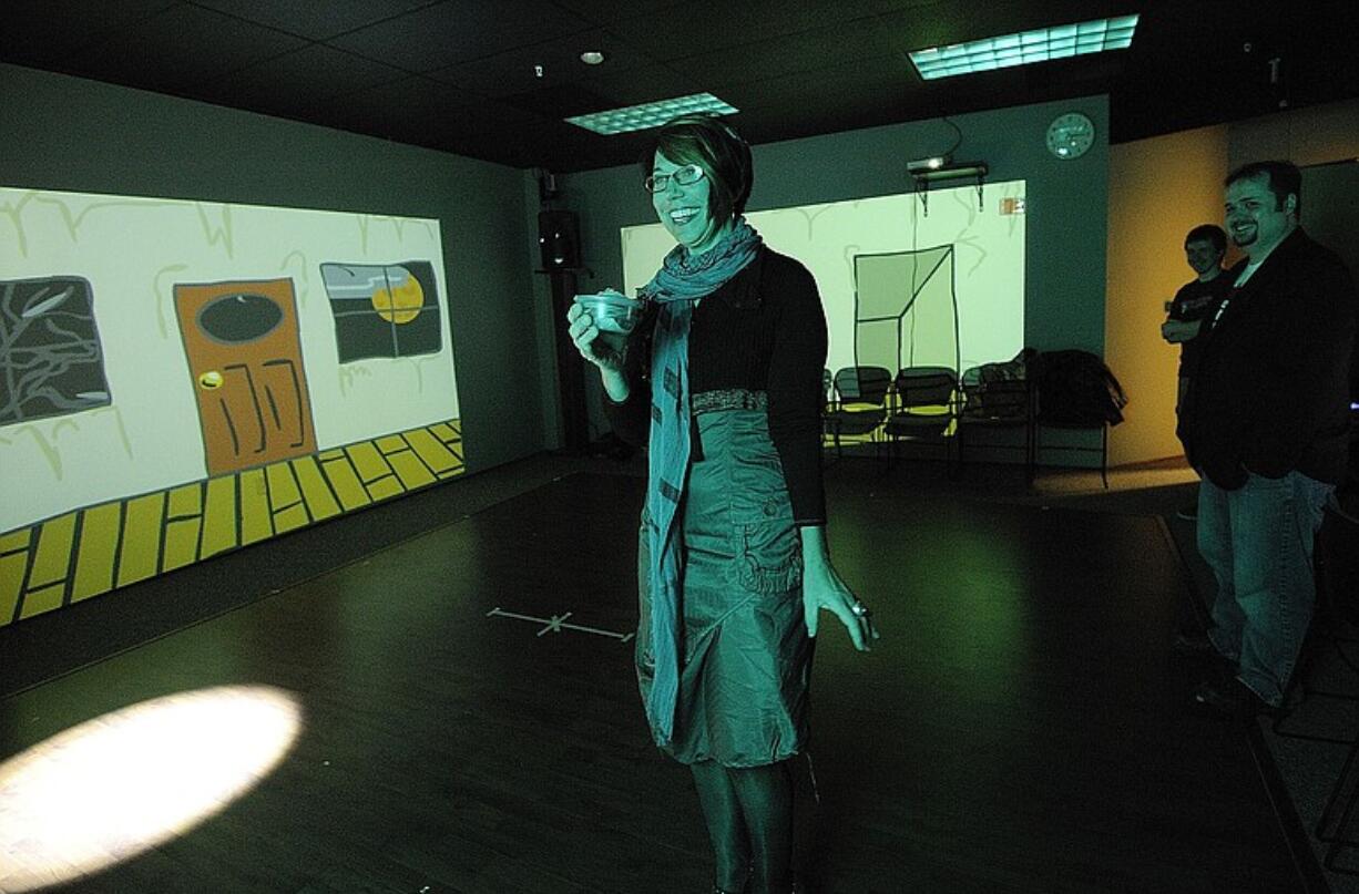 Anne Balsamo, a professor at the School of Cinematic Arts at the University of Southern California, uses a tracker device during a demonstration of the technology at Washington State University Vancouver.