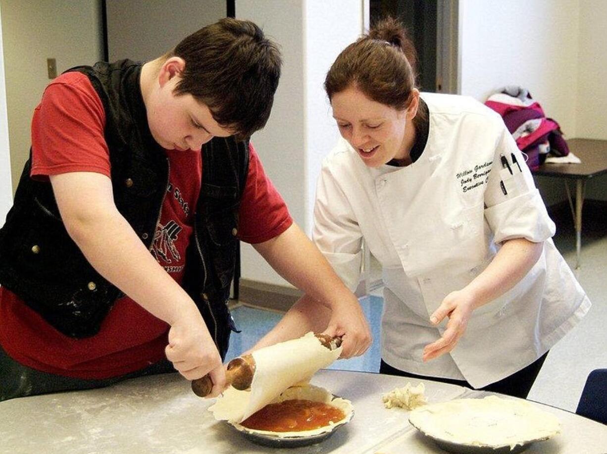 Washington State School for the Blind student Mike Timm from Oroville and Chef Jody Berrigan from Willow Gardens Retirement Home in Puyallup put the top crust a pie.