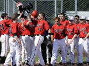 Teammates congratulate Austin Barr (15) on his three-run homer in the bottom of the first inning Tuesday for No.