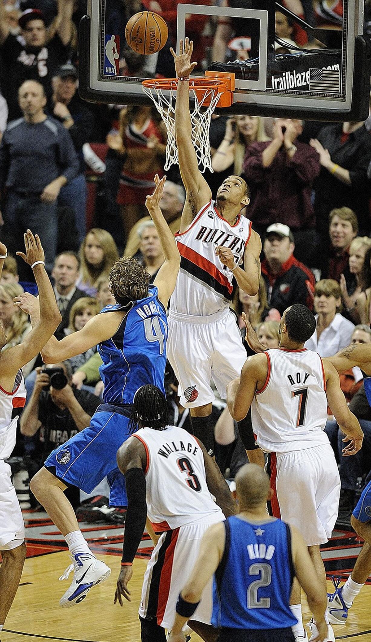 Chris Johnson, center, blocked two quick shots, including this one of Dallas' Dirk Nowitzki (41), after entering the game Thursday for the Blazers, sparking Portland to a Game 3 victory.