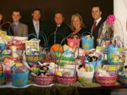 Sue Warren, from left, Chris Roberts, Vancouver Mayor Tim Leavitt, Brandon Dawson, Susie Oberst and Mason Walker stand behind Easter baskets donated to Share House.