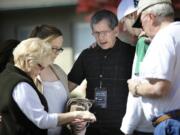 Brent Stahl, center, a member of City Harvest Church, offers a prayer with, from left, Pat Winn, Jennifer Zimmerman and her boyfriend, Jake Protasiewicz, and Jim Winn.