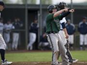 Evergreen's Will Pecson points toward teammate Zach Smith who drove him home with a single during an Evergreen sixth inning rally against Skyview on Thursday.