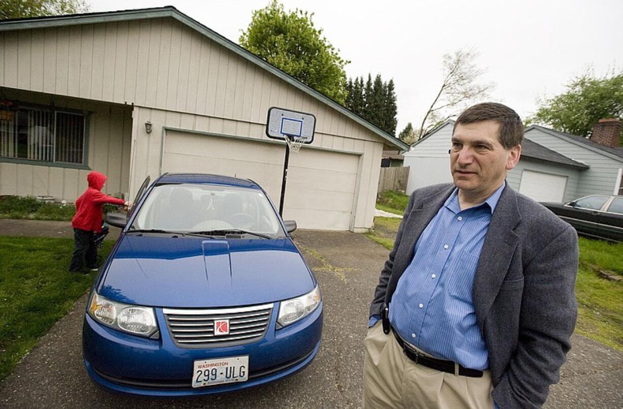 Fred Schwarz, with his son Aaron, prepares to leave for work at about 6:45 a.m.