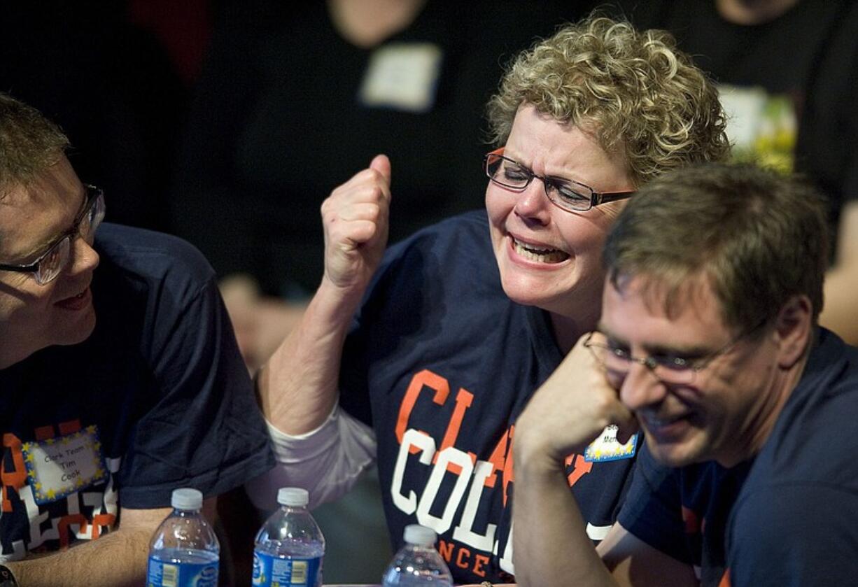 Clark College team members Tim Cook, left, Becky Merritt and Andrew Long react after misspelling &quot;vitreous&quot; during The Magic Spell, an adult spelling bee Sunday that raised money for scholarships and the library, at the Emil Fries Auditorium at the Washington State School for the Blind.