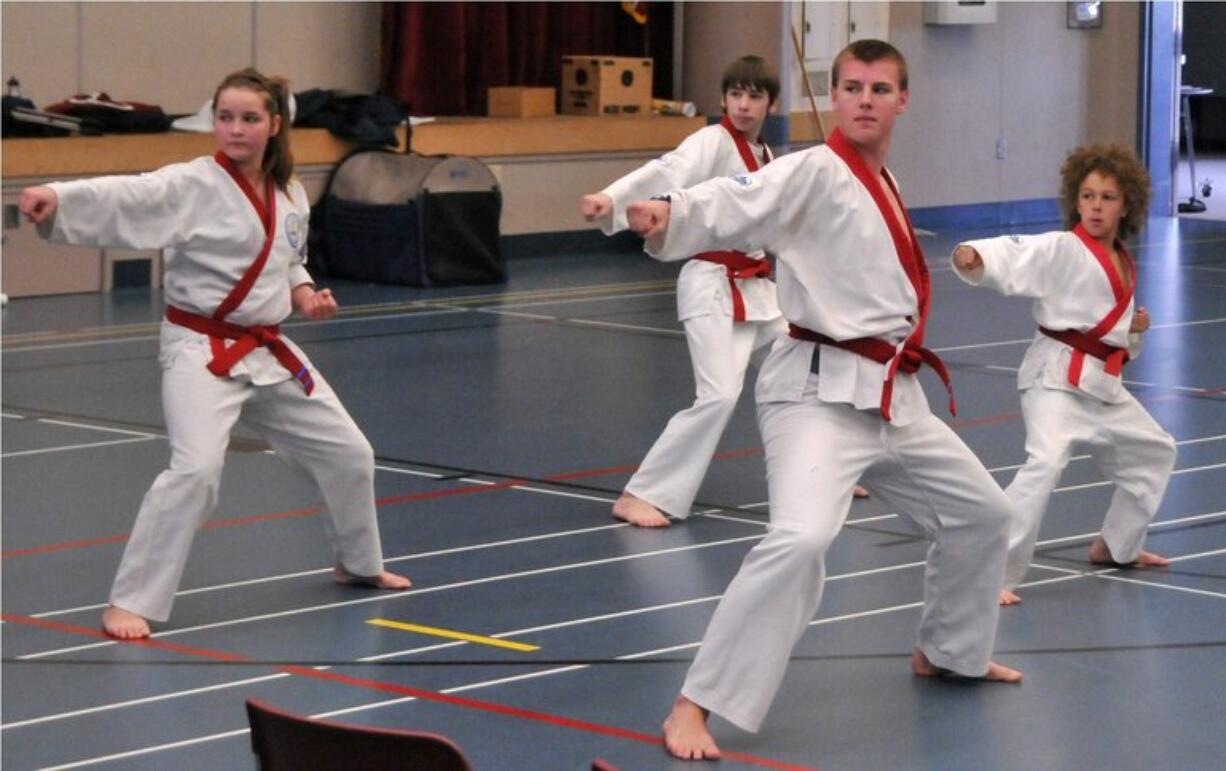 Camas martial arts students Jasmin Tuttle, from left, Jordan Johnson, Alistair Graham, and Ray Smith participated in a black belt exam May 14 in La Conner.