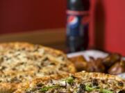 Vancouver-based Blazzin Pizza offers the Blazzin Supreme pizza, clockwise from bottom, Mark's Inferno Pizza and a side of regular wings at both its Cascade Park and new Hazel Dell-Salmon Creek locations.