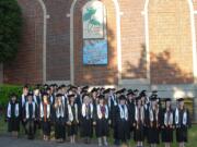 Vancouver School of Art and Academics 2011 graduating class members stand in front of a mural recently installed at the school and dedicated in their honor.