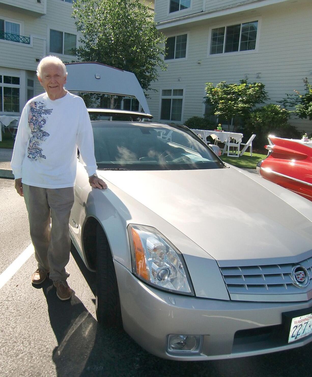 Waterford at Fairway Village resident Jim King displays his 2004 Cadillac XLR Roadster hardtop convertible during the retirement community's annual car show.