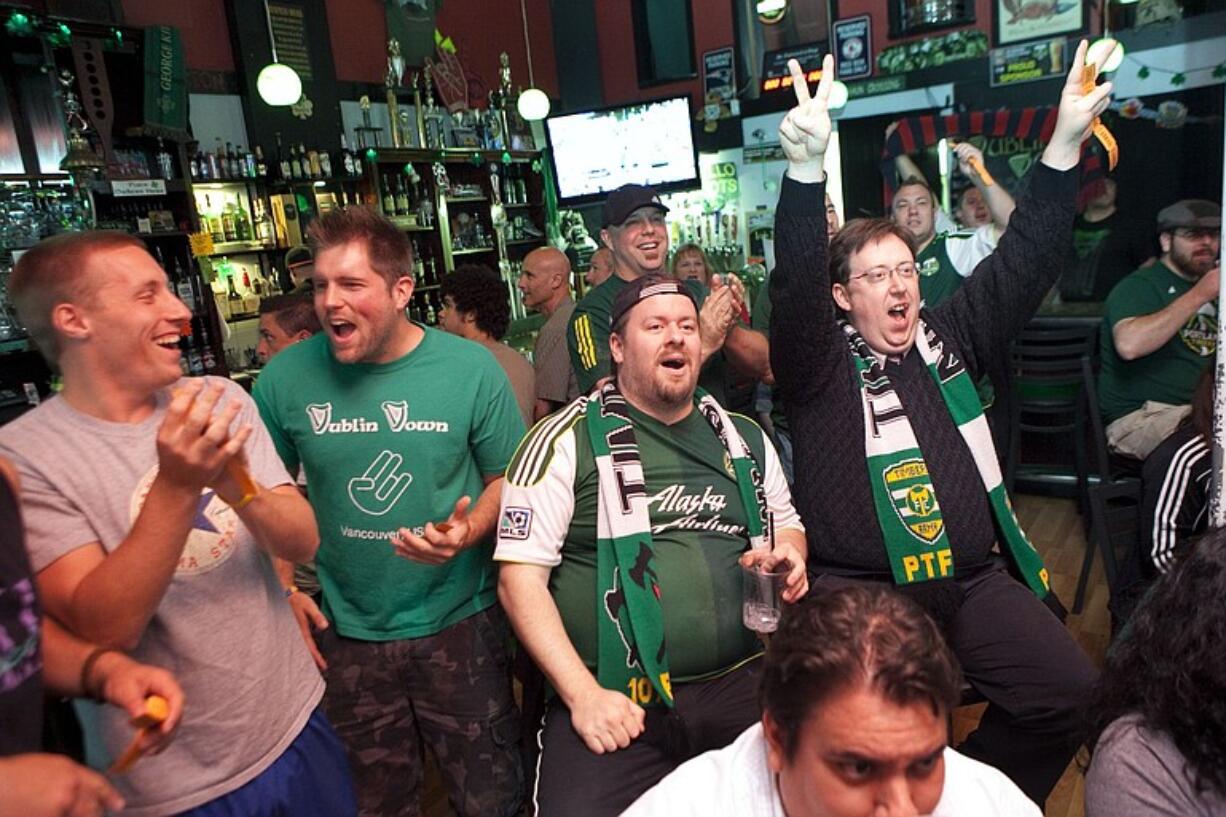 (From left) Zack Melnick, Kevin Lengvenis, Jon Lincicum and Brent Diskin -- part of the Timbers Army -- react to a play while watching a recent Timbers game at the Dublin Down Irish Pub in downtown Vancouver.