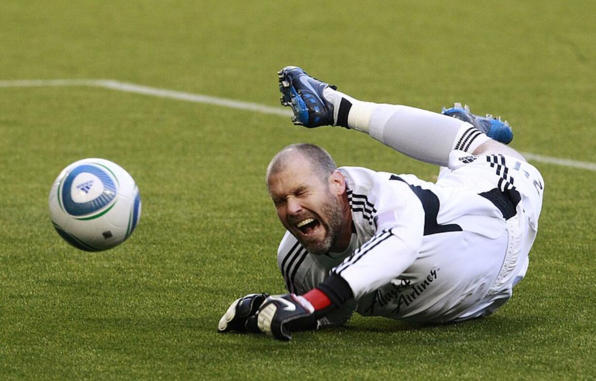 Portland Timbers goalkeeper Adin Brown (24) dives for the ball in the first half of a soccer game with Club America on Thursday.