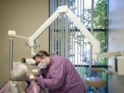 Dental assistant Traci Cotton X-rays a patient's mouth at New Day Community Dental Clinic in Vancouver last week.