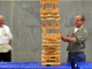 Gary Acton plays giant Jenga at the Evergreen Habitat for Humanity Tool Box Bash.