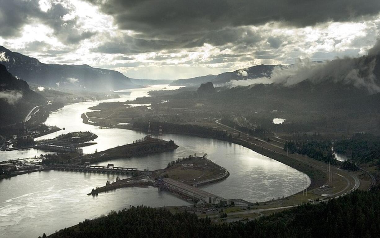 This aerial photograph of the Columbia River Gorge from 2006 shows the view looking west with Bonneville Dam in the foreground.