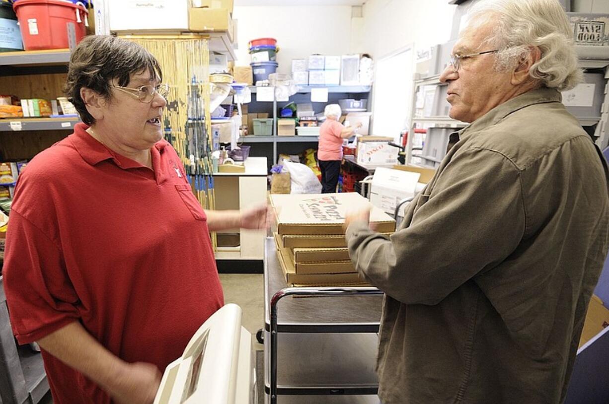 Elaine Hertz talks turkey -- donated, of course -- with volunteer Bob Narciso.