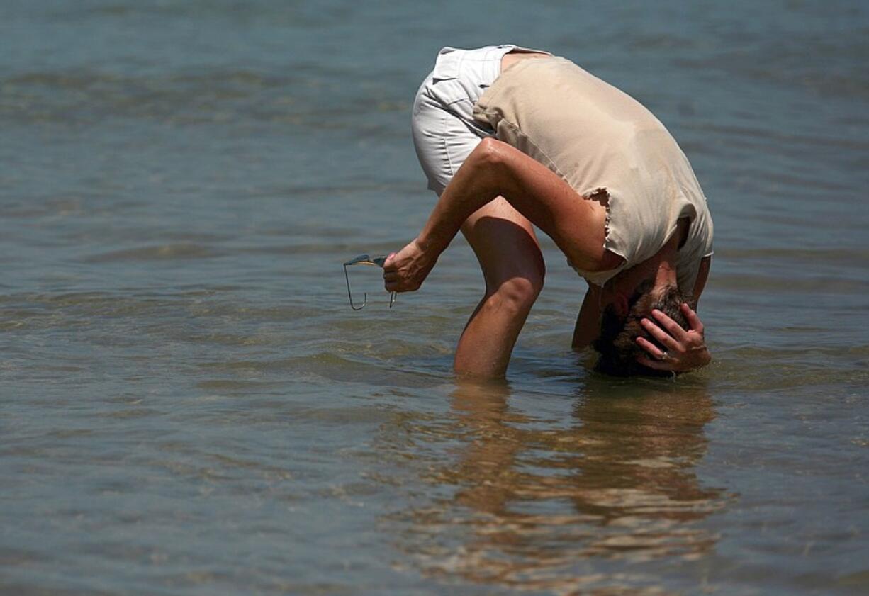 A beachgoer attempts to stay cool Wednesday at Ohio Street Beach in Chicago.