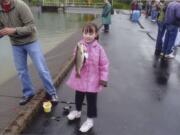 Eight-year-old Riley Kinne, of Vancouver, holds her first trout July 16 at Merwin Speical Kids' Day.