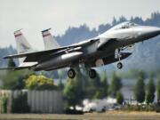 F-15 C model single seat jet fighters with the Oregon Air National Guard take off from Portland International Airport.