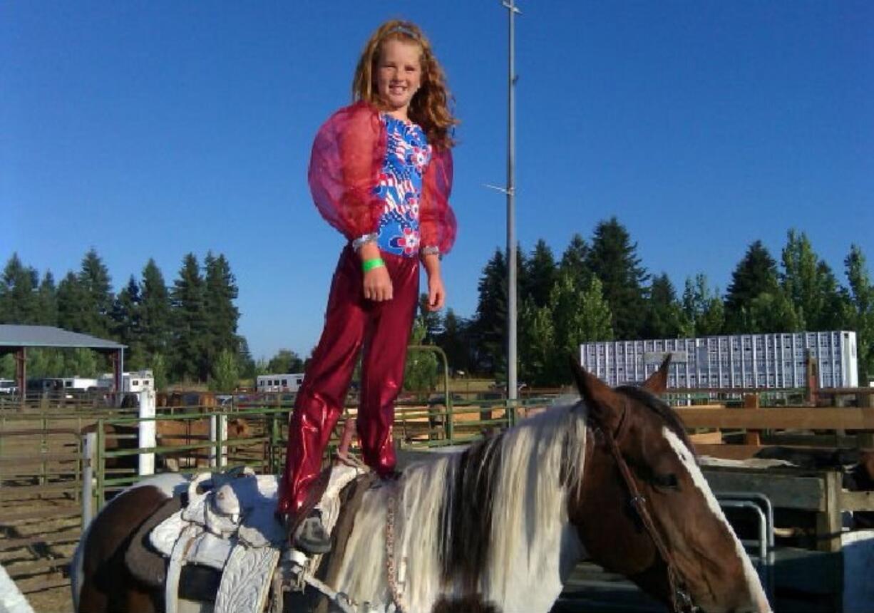 Brush Prairie: Riley McMillan, 10, prepares to carry the flag around the arena at the second-annual Joe Meling Invitational Bull Riding event at the Clark County Saddle Club.