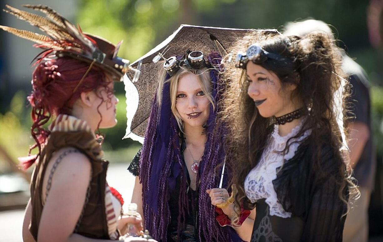 Anime fans Sarah Schwartz, 18, from left, Corissa Meadors, 22, and Sablahn Lighty, 17, all of Portland, hang out in Propstra Square on Monday.