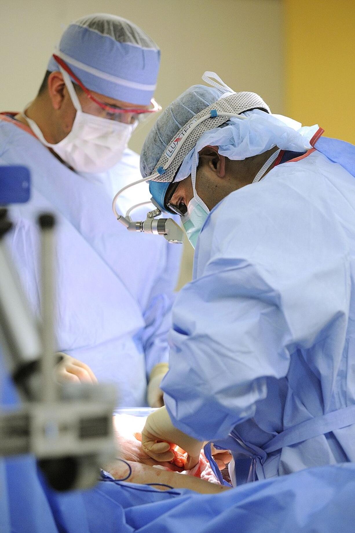 Dr. Allen Gabriel performs breast reconstruction surgery on patient Krista Colvin at PeaceHealth Southwest Medical Center in Vancouver last year.