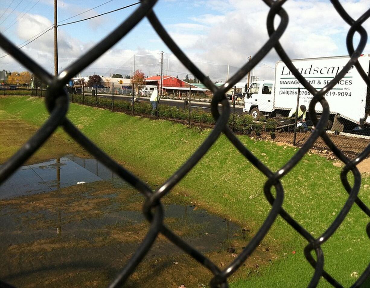 A landscaping truck sits parked near an area around a stormwater pond being built near Northeast Tenney Road and Northeast 139th Street in Salmon Creek.