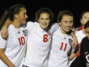 Camas players including Lauren Oljar (10), Alex Dombek (6) and Olivia Howell (11) celebrate their win over Kelso for the league title.