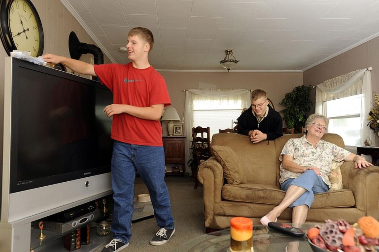 Marty Embleton, right, chats with her grandsons, Nick, left, and Alex Embleton at their home in Vancouver.