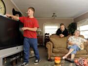 Marty Embleton, right, chats with her grandsons, Nick, left, and Alex Embleton at their home in Vancouver.