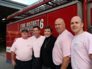 Northeast Hazel Dell: Clark County Fire District 6 firefighters show off their pink shirts in honor of Breast Cancer Awareness Month. From left, Firefighter Bob Hamel, Capt.