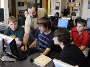 Joseph Sliger, with beard, an applications specialist for Wacom, demonstrates the use of the pressure-sensitive digital pen on one of several newly purchased Wacom computer tablets to Union High School students, from left, Russell Beaver, Austin Klein, Aaron Siegel and Trey Cornish.