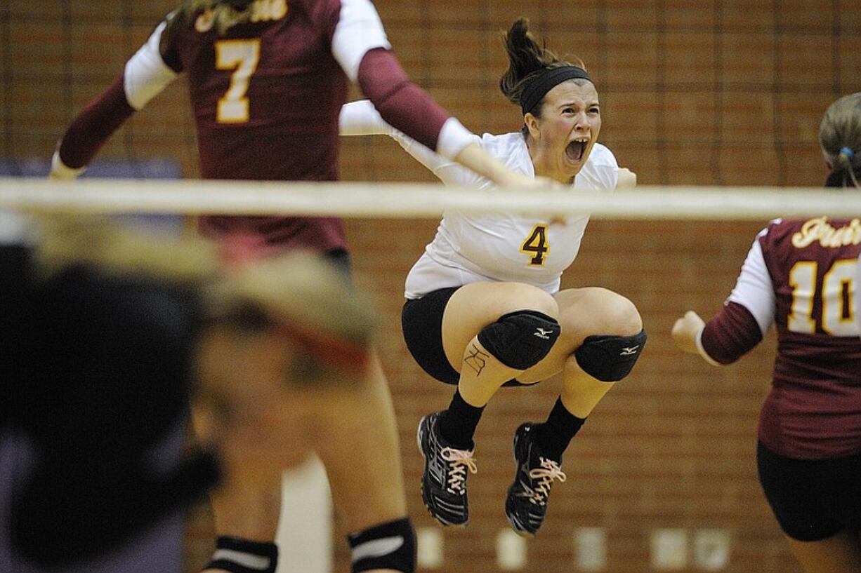 Prairie's Katie Pagel (4) celebrates with her teammates after beating Camas for the district volleyball championship on Tuesday.