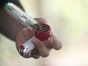 A Clark College student takes a marijuana smoke break with friends after class near the amphitheater at Vancouver's Water Works Park Nov.