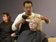 Photos by Ariane Kunze/The Columbian
Carmen Dean gets her hair cut and styled by Derek Thompson on Thursday at Project Homeless Connect at St. Joseph Catholic Church in Vancouver. Dean attended the annual event to receive mental health services, a flu shot and some new clothes, she said.