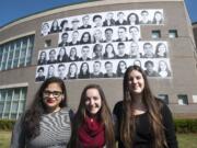 At Skyview High School, behind student photographers Rubyna Ali, from left, Shelby Sherman and Marta Alcazar, are the 40 portraits they selected to represent the school's diversity.