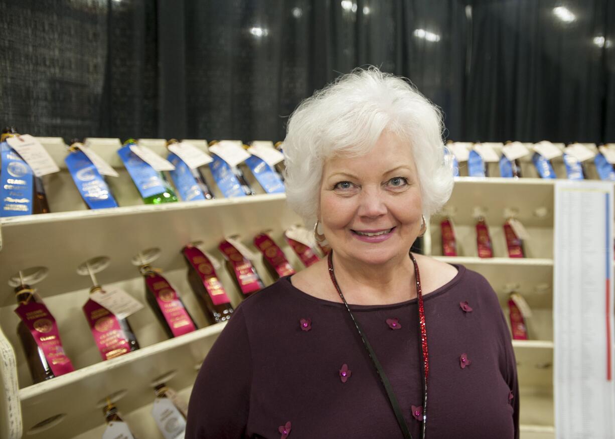 Jennifer Petersen mans her booth Wednesday at the Clark County Fair in Rdigefield, where she was also a judge for the scone-baking contest.