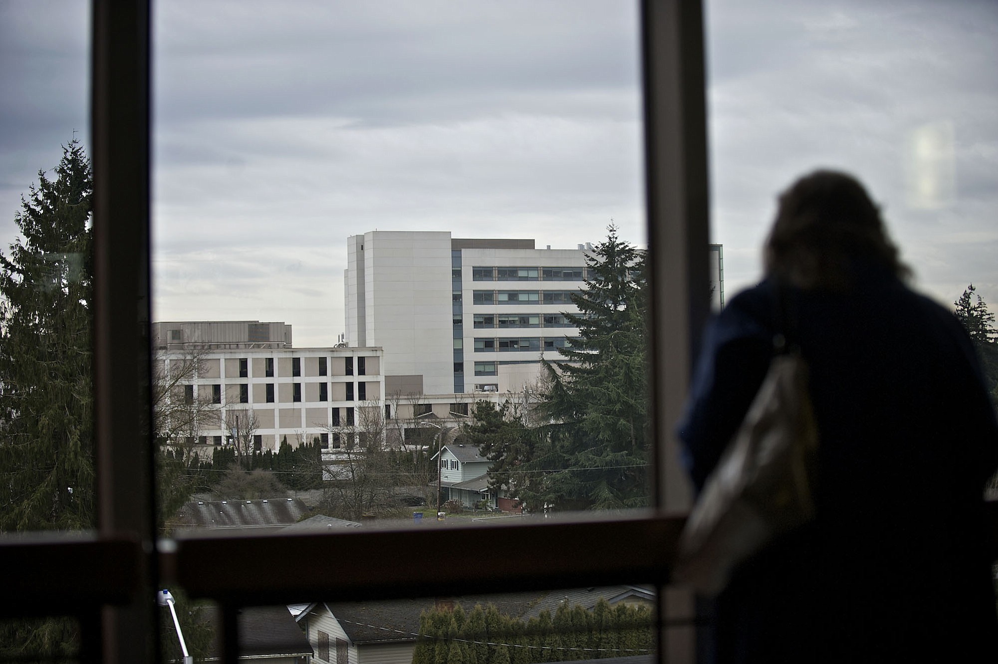 Evergreen Public Schools Director of Community Relations Carol Fenstermacher looks out a third story window toward Peace Health Southwest Medical Center, during a tour on Wednesday February 20, 2013, of the new Henrietta Lacks Health and Bioscience High School, which will have a partnership with the hospital.