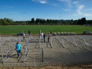 La Center High School students, staff, administrators and parents help with the construction of the new football stadium on Friday.