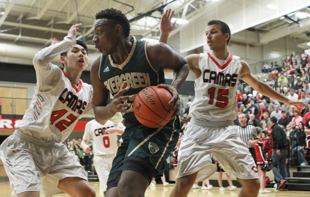 Evergreen High School player Robert Franks tries to control the ball as Camas High School players Kantas Zalpys (15) and Bryan Nguyen (42) surround him during Friday's 4A GSHL game at Camas.